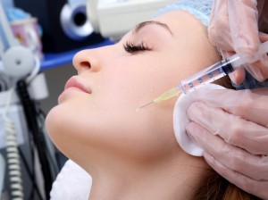 Doctor woman giving botox injections.