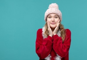 front view young female in warm clothes with garlands on blue background xmas holiday color emotion woman beauty new year